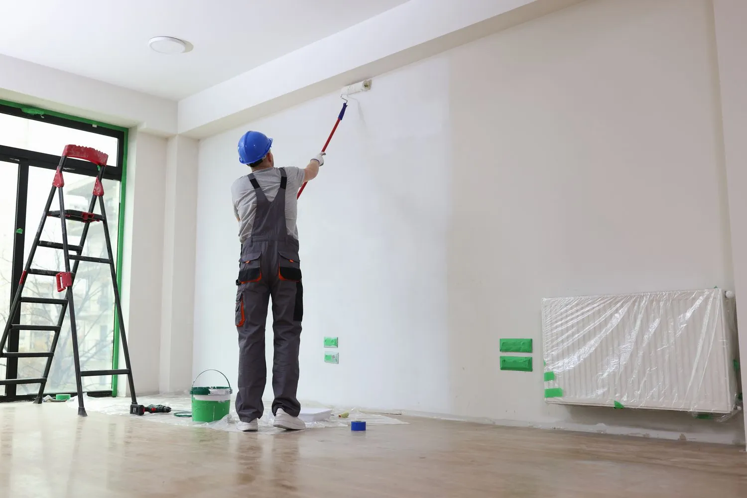 Professional painter refreshing an interior wall